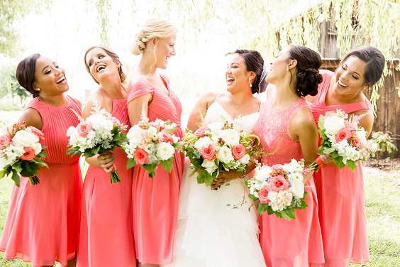 coral bridesmaid dresses and a white wedding gown for summer wedding colors combos for 2025 coral and pink
