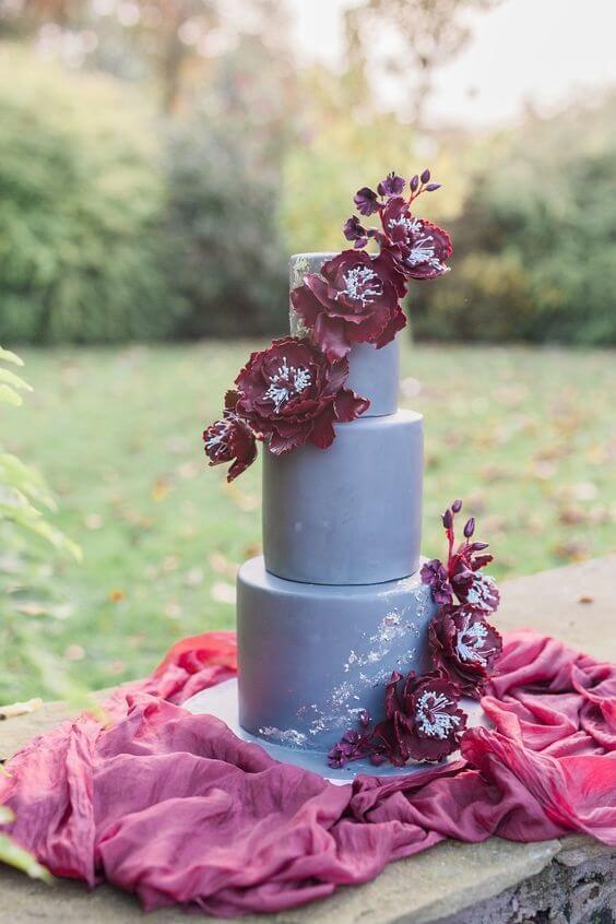 light grey wedding cake with purple flowers for fall grey and burgundy wedding