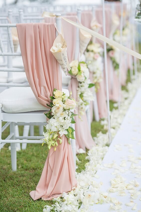 aisle decor with dusty rose drapes and white and yellow flowers for spring dusty rose wedding