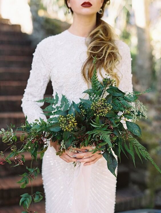 white bridal gown paired with greenery bouquets for fall dark green wedding