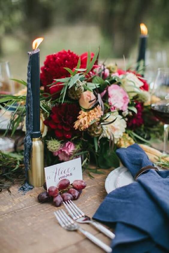 maroon flower centerpiece and navy blue candles for fall maroon and navy blue wedding