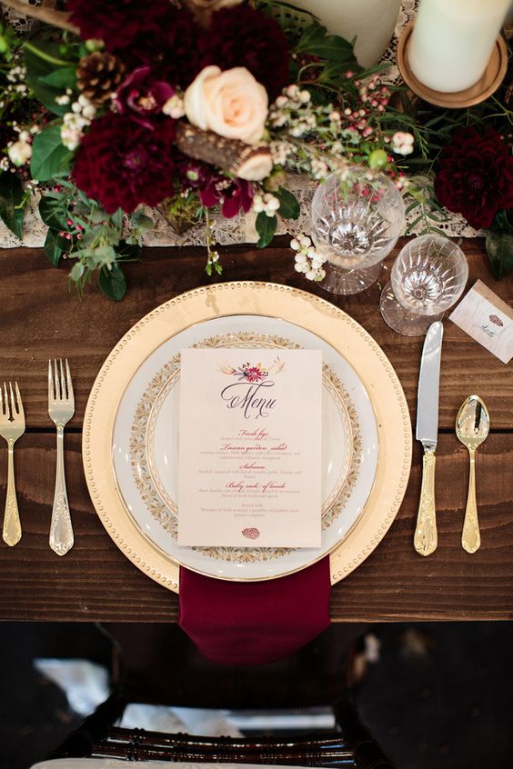 burgundy napkin and gold plate place setting for fall burgundy wedding
