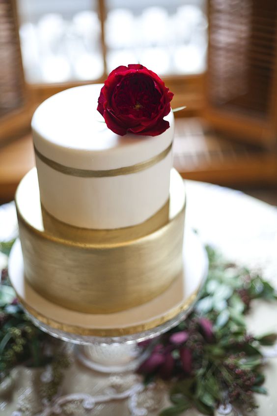 gold wedding cake with dark red flowers for fall burgundy wedding
