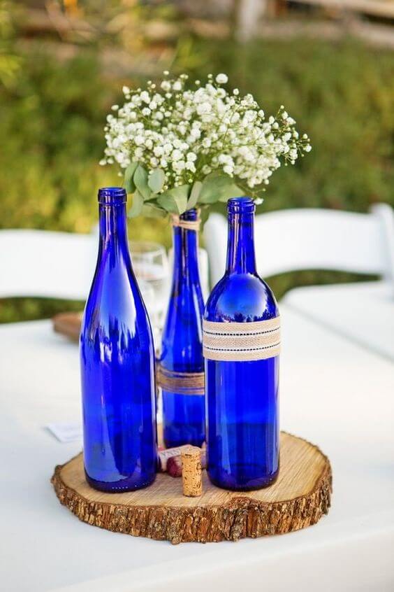 tree slab and royal blue wine bottle centerpiece for summer royal blue wedding