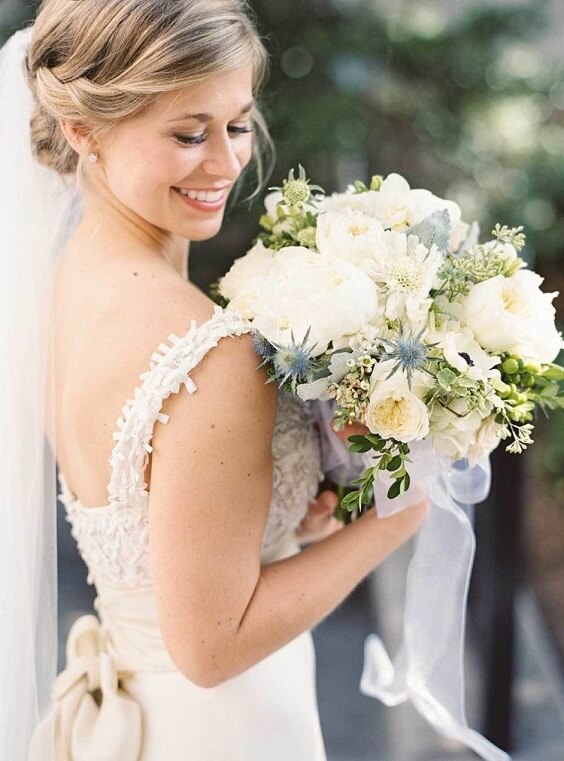 bride with bouquets for spring dusty blue wedding