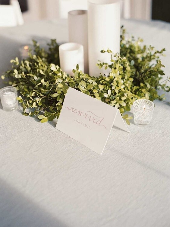 white candles and table number card with greenery decorations for spring dusty blue wedding