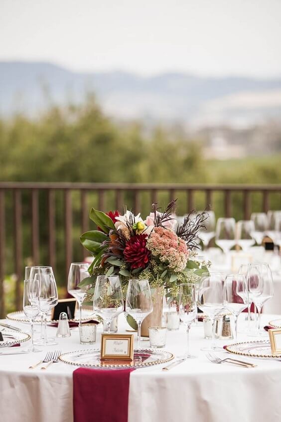 table setting for fall champagne and burgundy wedding
