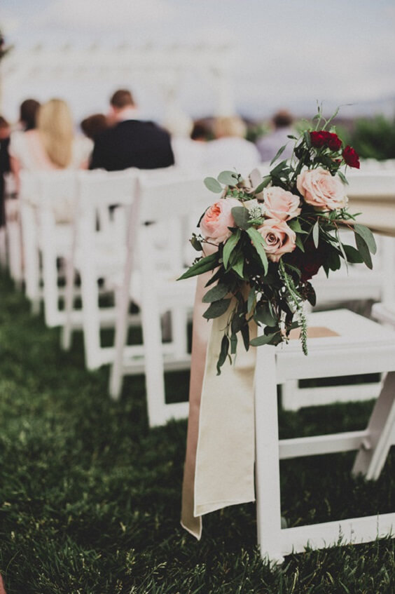 white chairs and flower decorations for fall dusty rose wedding