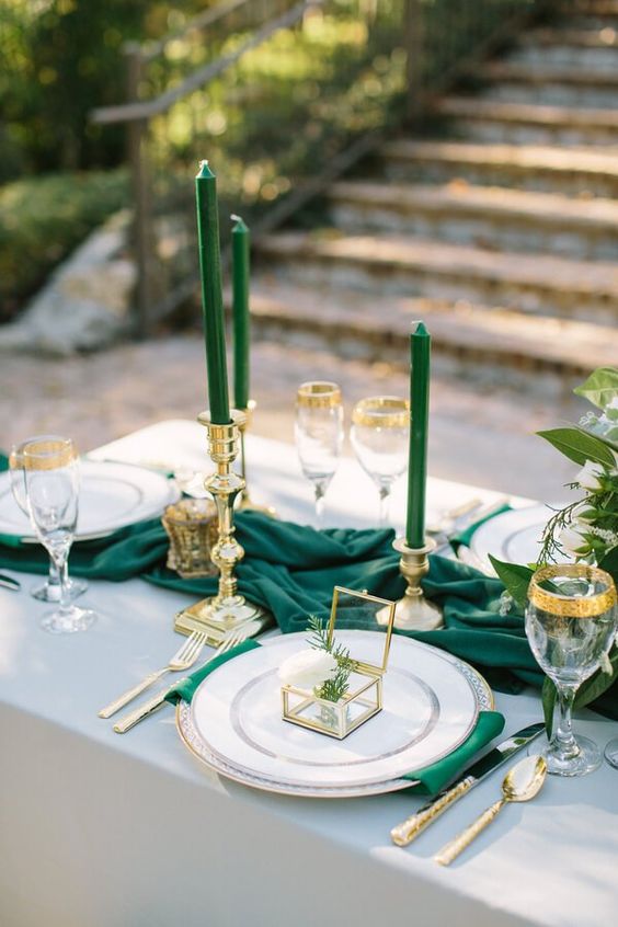 green candles and gold plate settings for winter green wedding
