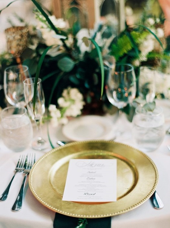 green centerpiece and gold plate for winter green wedding