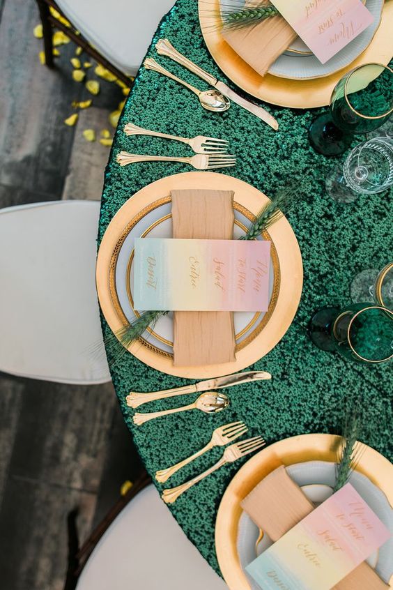 green tablecloth and gold place setting for winter green wedding